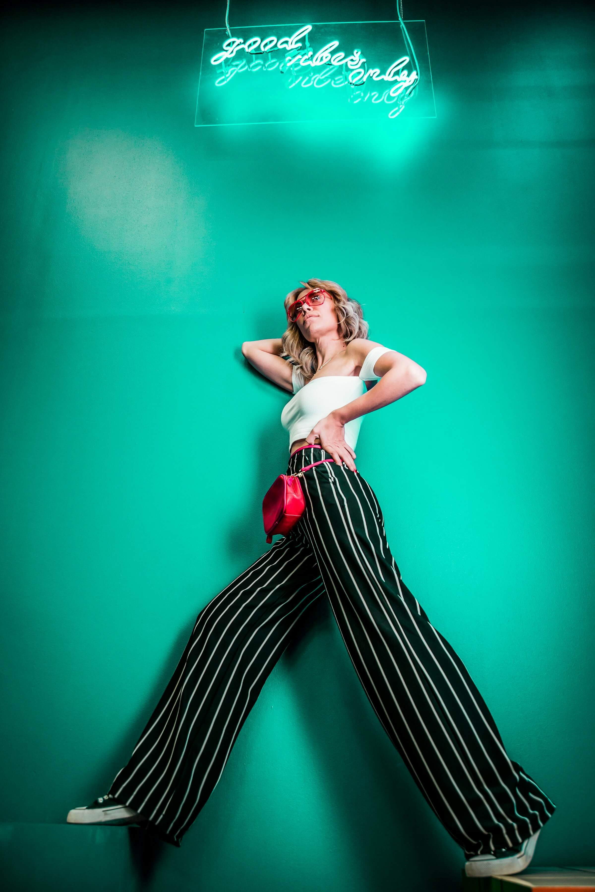 High-fashion editorial image featuring model in luxury evening wear with warm golden lighting